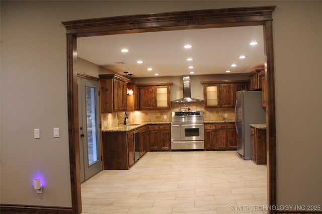 2148 E Wise Rd, Mcalester, OK 74501 - kitchen featuring appliances with stainless steel finishes, wall chimney exhaust hood, decorative backsplash, light stone countertops, and recessed lighting