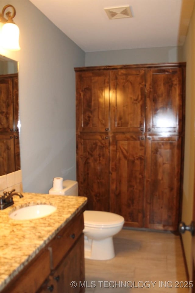 2148 E Wise Rd, Mcalester, OK 74501 - bathroom with wood finished floors, vanity, and lofted ceiling