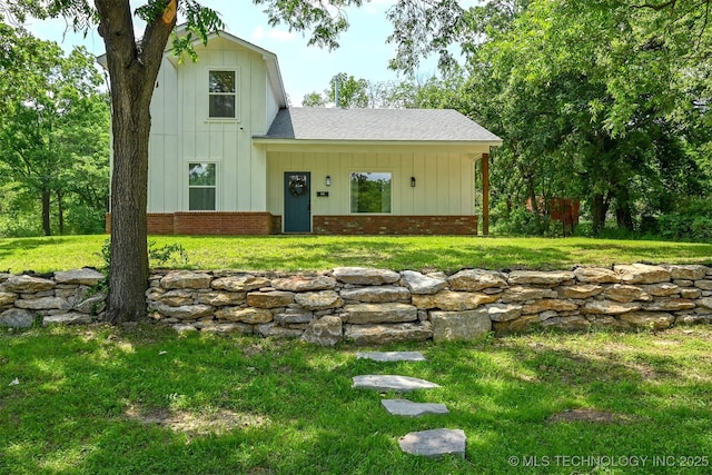 3608 S 31st W Ave, Tulsa, OK 74107 - view of front of home featuring board and batten siding, a front lawn, roof with shingles, and brick siding