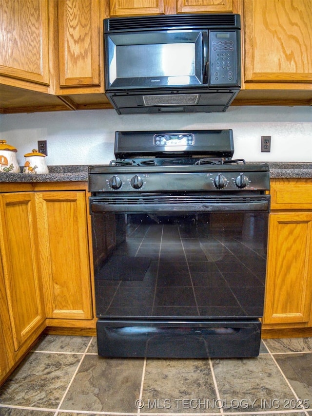 447 Pink Gladiola St, Broken Bow, OK 74745 - kitchen featuring black microwave, range with gas cooktop, dark countertops, and brown cabinetry
