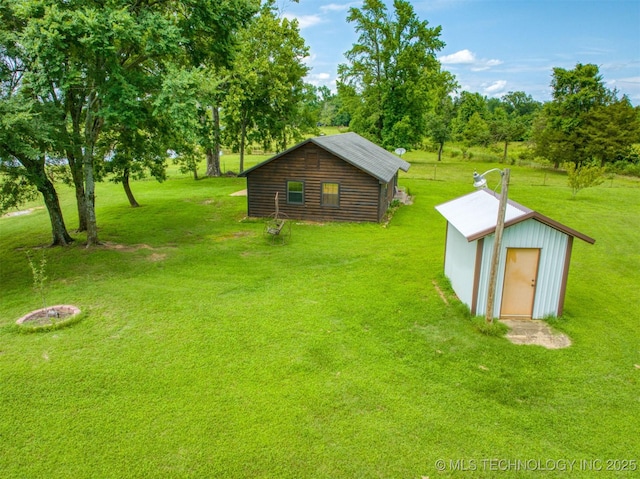 447 Pink Gladiola St, Broken Bow, OK 74745 - view of grassy yard featuring an outdoor structure and view of scattered trees