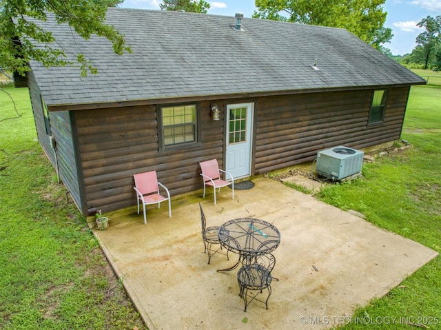 447 Pink Gladiola St, Broken Bow, OK 74745 - rear view of property with a shingled roof, a patio, a yard, and faux log siding