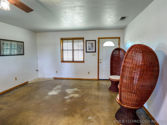 447 Pink Gladiola St, Broken Bow, OK 74745 - foyer entrance featuring concrete flooring and ceiling fan