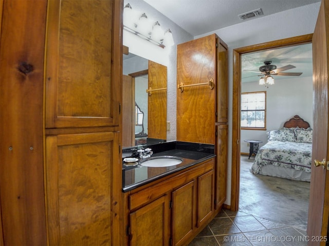 447 Pink Gladiola St, Broken Bow, OK 74745 - bathroom with vanity, ceiling fan, ensuite bath, and tile patterned floors