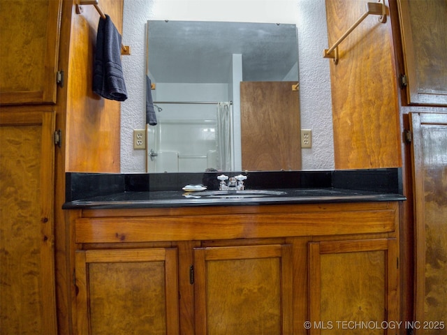 447 Pink Gladiola St, Broken Bow, OK 74745 - full bathroom with a textured wall, vanity, and a shower