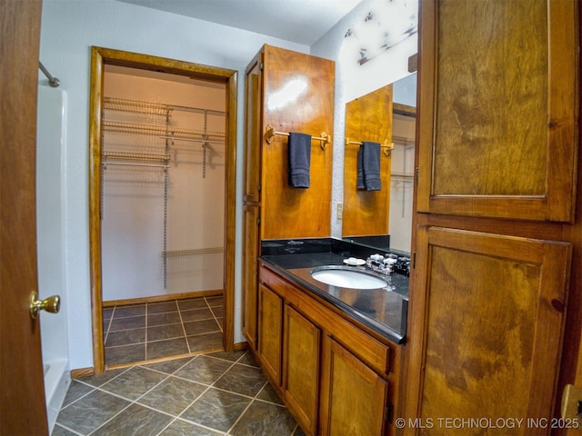 447 Pink Gladiola St, Broken Bow, OK 74745 - bathroom with vanity, a spacious closet, and a shower
