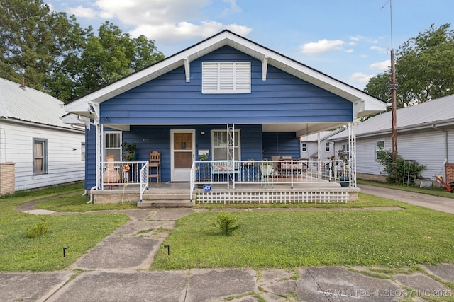 805 W Gentry St, Henryetta, OK 74437 - shotgun-style home with covered porch and a front lawn