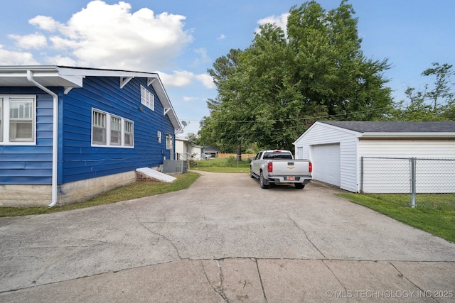 805 W Gentry St, Henryetta, OK 74437 - view of side of home featuring concrete driveway, an outbuilding, and a garage