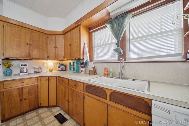805 W Gentry St, Henryetta, OK 74437 - kitchen featuring dishwasher, crown molding, light countertops, and brown cabinetry
