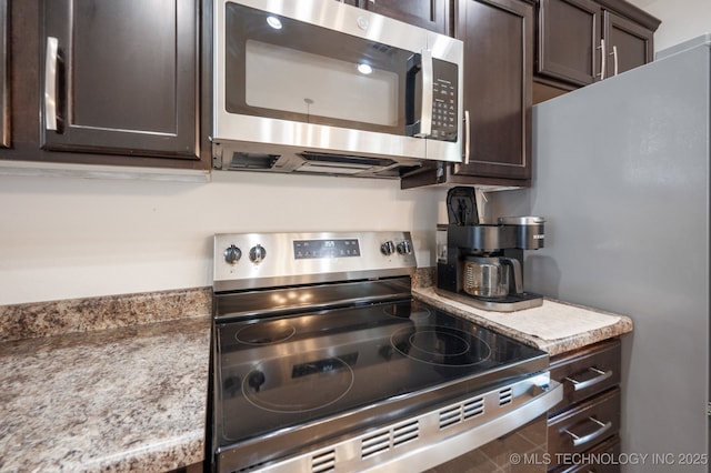 8661 S 264th E Ave, Broken Arrow, OK 74014 - kitchen with appliances with stainless steel finishes and dark brown cabinets