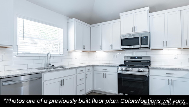 219 S 25th St, Collinsville, OK 74021 - kitchen featuring stainless steel appliances, white cabinetry, and backsplash
