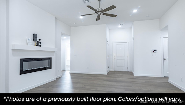 219 S 25th St, Collinsville, OK 74021 - unfurnished living room with wood finished floors, ceiling fan, a glass covered fireplace, and recessed lighting