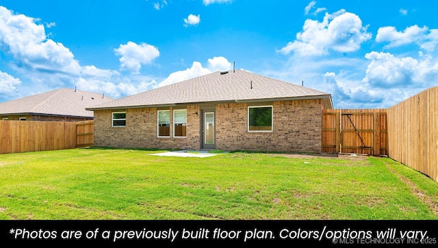 219 S 25th St, Collinsville, OK 74021 - rear view of property featuring brick siding, a fenced backyard, and a shingled roof