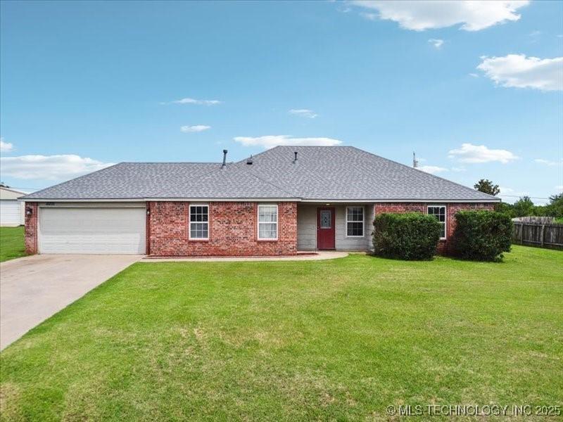 12275 Valley Ave, Owasso, OK 74021 - ranch-style house with an attached garage, driveway, brick siding, and roof with shingles