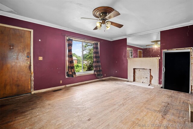 917 N Knoxville Ave, Tulsa, OK 74115 - unfurnished living room featuring a ceiling fan, a fireplace with flush hearth, ornamental molding, and hardwood / wood-style floors