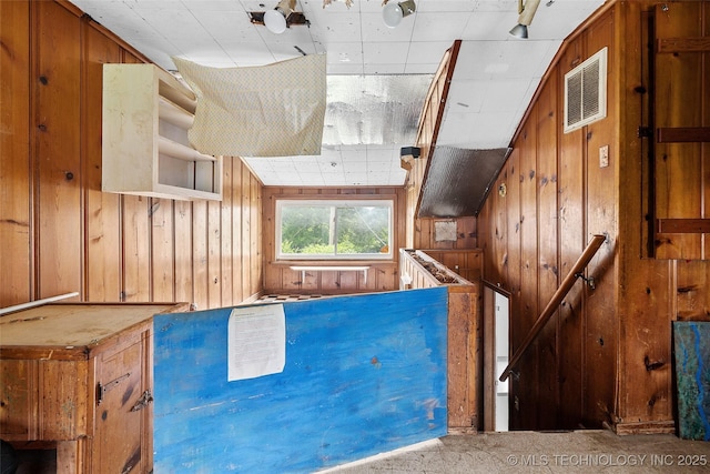 917 N Knoxville Ave, Tulsa, OK 74115 - interior space with wood walls and an upstairs landing