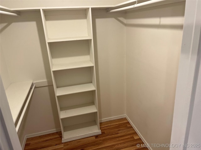 1918 E 14th, Ada, OK 74820 - walk in closet with dark wood-style floors