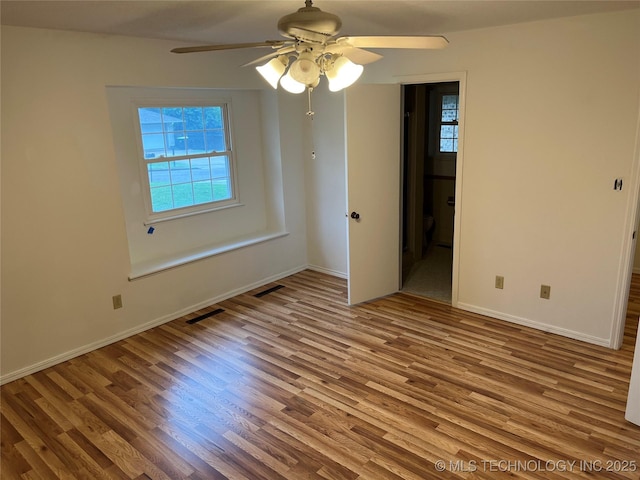 1918 E 14th, Ada, OK 74820 - unfurnished room with a ceiling fan, plenty of natural light, and wood finished floors