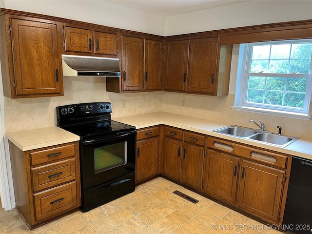 1918 E 14th, Ada, OK 74820 - kitchen featuring extractor fan, black appliances, and light countertops