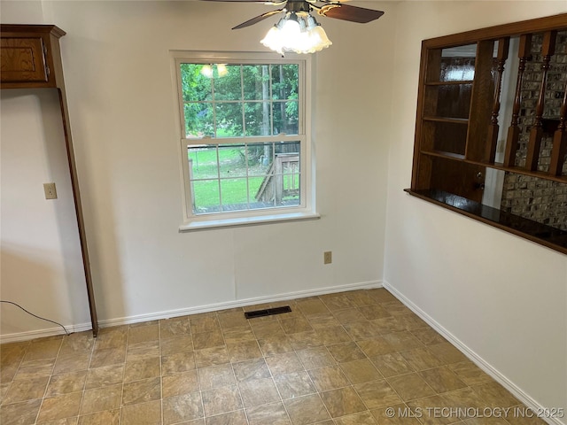 1918 E 14th, Ada, OK 74820 - unfurnished dining area with a ceiling fan and baseboards