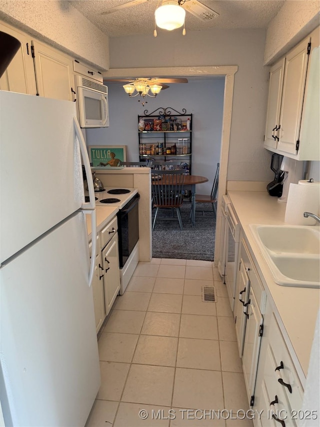 450779 E 341st Rd Unit 34, Afton, OK 74331 - kitchen featuring white appliances, light tile patterned floors, light countertops, a chandelier, and a textured ceiling