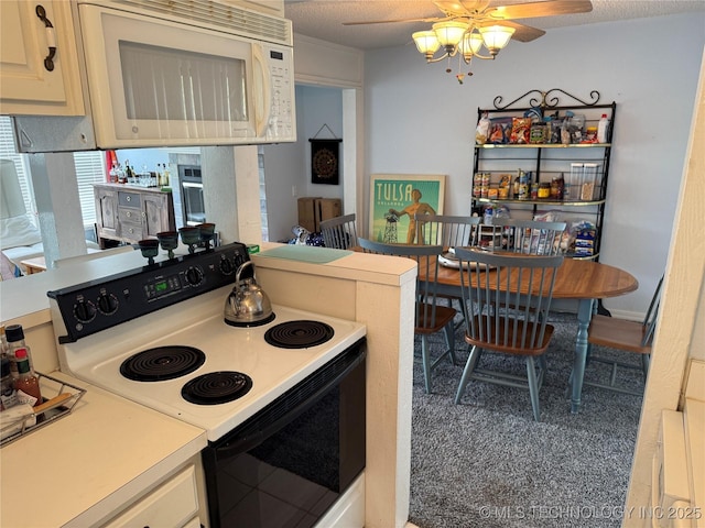 450779 E 341st Rd Unit 34, Afton, OK 74331 - kitchen with electric range oven, white microwave, a ceiling fan, and light countertops