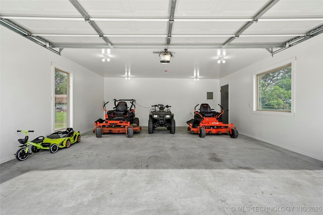 13514 N 97th E Ave, Collinsville, OK 74021 - garage featuring a garage door opener and baseboards