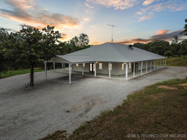 4127 New Prue Rd, Sand Springs, OK 74063 - view of front of property with gravel driveway, a metal roof, a porch, and a standing seam roof