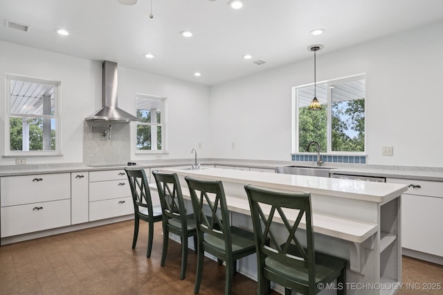 4127 New Prue Rd, Sand Springs, OK 74063 - kitchen featuring wall chimney range hood, white cabinets, light countertops, a kitchen island, and recessed lighting