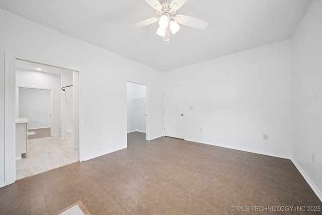 4127 New Prue Rd, Sand Springs, OK 74063 - unfurnished bedroom with a walk in closet, ensuite bathroom, ceiling fan, and a closet