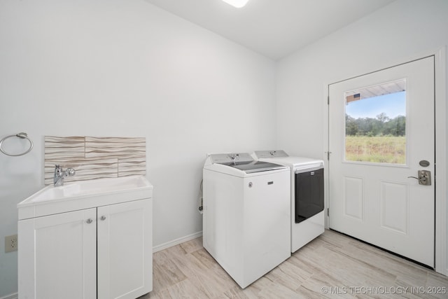 4127 New Prue Rd, Sand Springs, OK 74063 - washroom featuring washer and dryer, cabinet space, and light wood-style floors