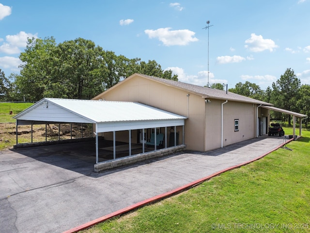 4127 New Prue Rd, Sand Springs, OK 74063 - back of house featuring a lawn and asphalt driveway