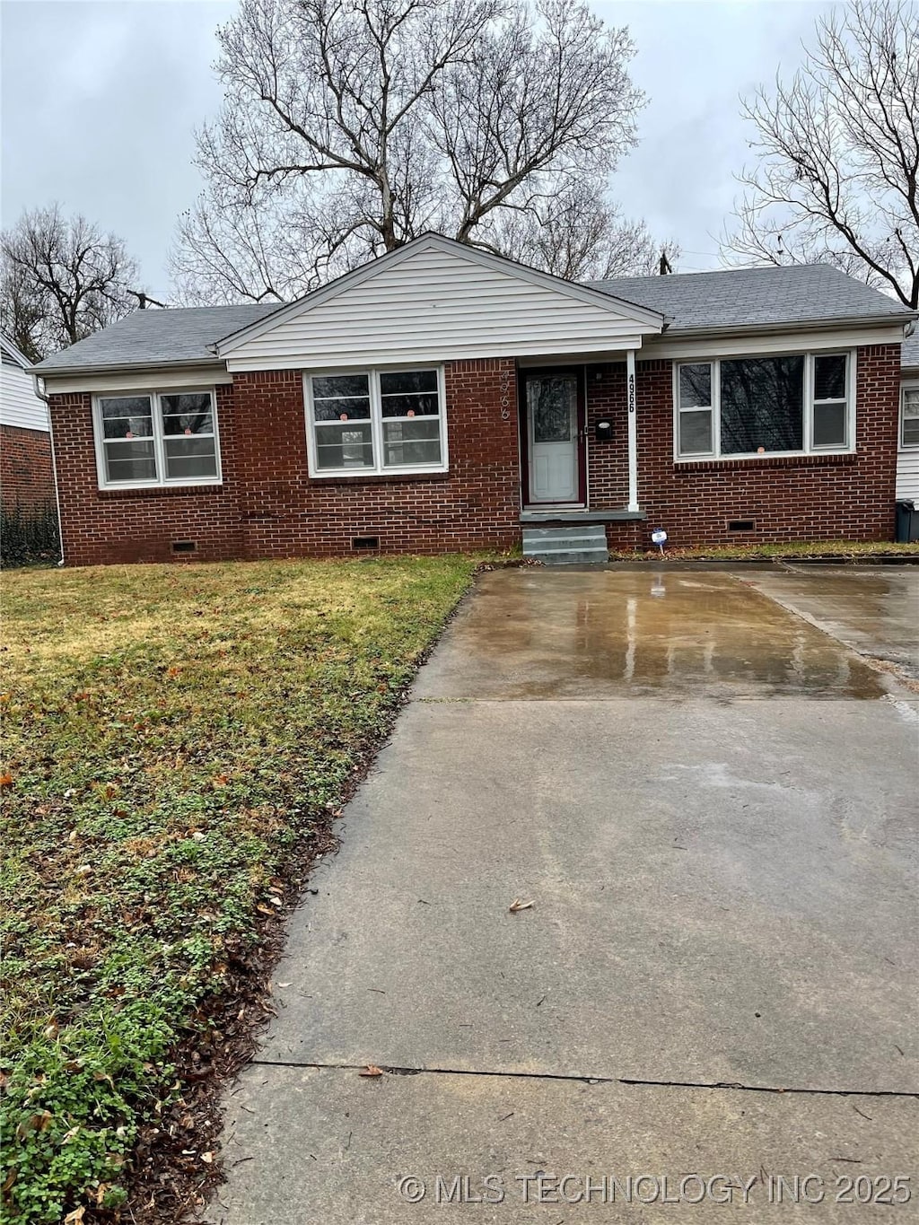 4966 S Madison Ave, Tulsa, OK 74105 - view of front of house featuring crawl space, brick siding, driveway, and a front yard