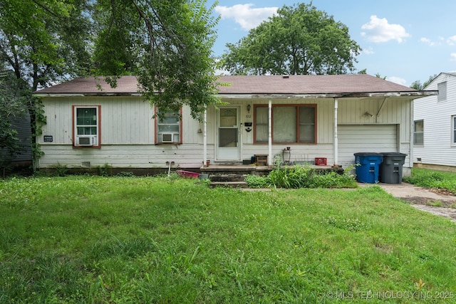 1012 N Irvington St, Tulsa, OK 74115 - view of front of property featuring a garage, a porch, a front lawn, and driveway