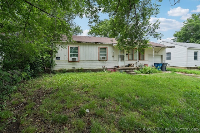 1012 N Irvington St, Tulsa, OK 74115 - view of front facade featuring a garage, cooling unit, and board and batten siding
