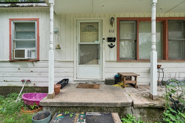 1012 N Irvington St, Tulsa, OK 74115 - doorway to property featuring covered porch and cooling unit