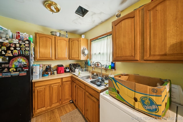 1012 N Irvington St, Tulsa, OK 74115 - kitchen with freestanding refrigerator, light countertops, light wood-style floors, and brown cabinets