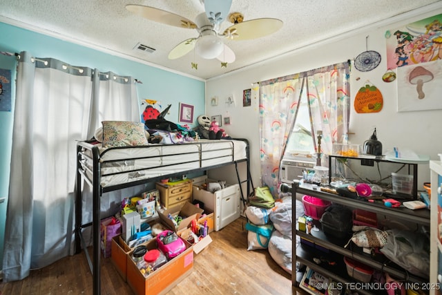1012 N Irvington St, Tulsa, OK 74115 - bedroom featuring a textured ceiling, wood finished floors, crown molding, a ceiling fan, and cooling unit