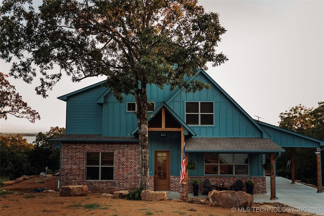 118900 S 4213, Eufaula, OK 74432 - view of front of house featuring board and batten siding, a shingled roof, and brick siding