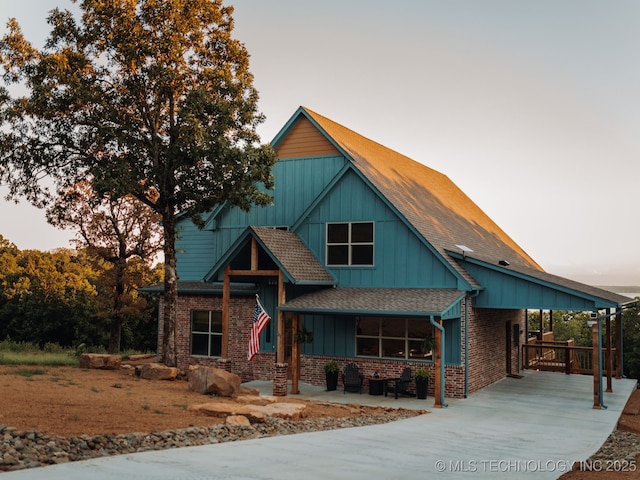 118900 S 4213, Eufaula, OK 74432 - view of front facade featuring driveway, board and batten siding, brick siding, and a shingled roof
