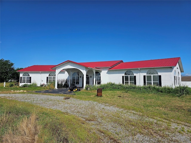38032 State Road 78 W, Durant, OK 74701 - ranch-style house with stucco siding and a metal roof