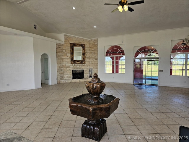38032 State Road 78 W, Durant, OK 74701 - living room featuring light tile patterned flooring, a ceiling fan, healthy amount of natural light, lofted ceiling, and a textured ceiling