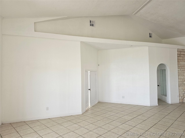 38032 State Road 78 W, Durant, OK 74701 - unfurnished room featuring light tile patterned floors, high vaulted ceiling, and arched walkways
