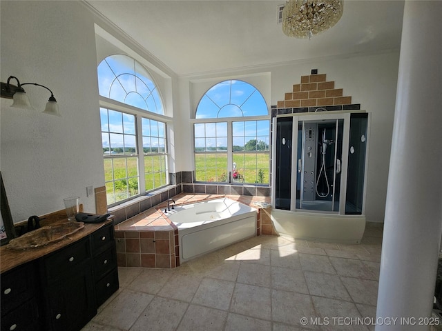 38032 State Road 78 W, Durant, OK 74701 - full bath featuring a bath, stone tile floors, ornamental molding, vanity, and decorative columns