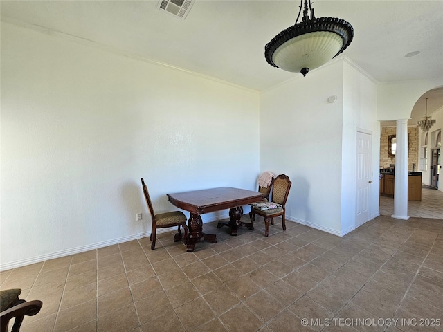 38032 State Road 78 W, Durant, OK 74701 - tiled dining room with decorative columns, arched walkways, and crown molding