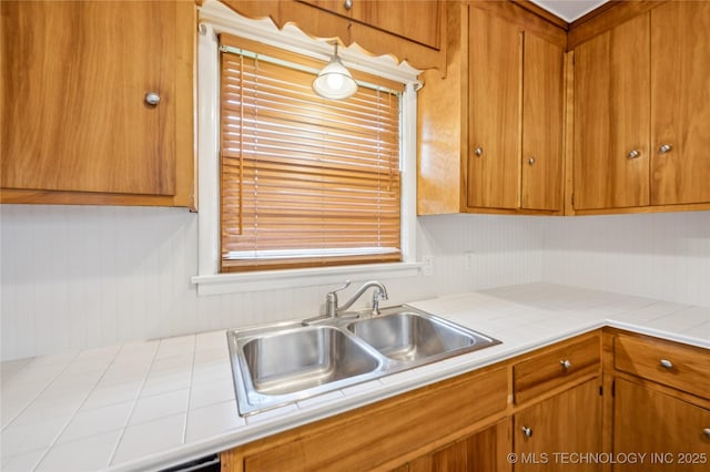 2178 S 76th E Ave, Tulsa, OK 74129 - kitchen featuring brown cabinetry and tile counters