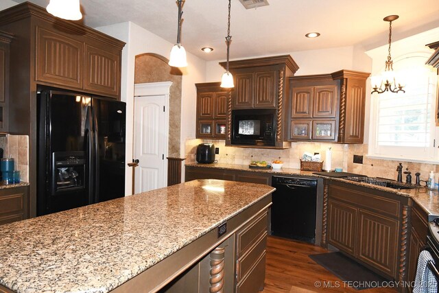 2463 S Park Hl, Tahlequah, OK 74464 - kitchen featuring black appliances, backsplash, light stone countertops, pendant lighting, and a chandelier