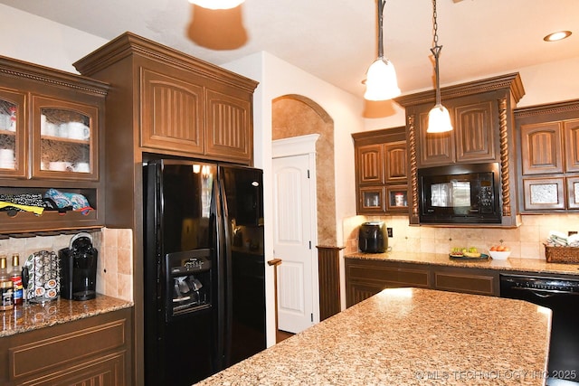 2463 S Park Hl, Tahlequah, OK 74464 - kitchen with black appliances, tasteful backsplash, glass insert cabinets, light stone countertops, and hanging light fixtures