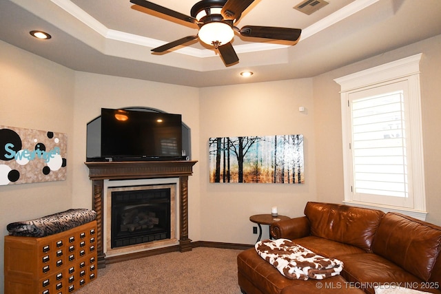 2463 S Park Hl, Tahlequah, OK 74464 - carpeted living room featuring a raised ceiling, a ceiling fan, a tile fireplace, ornamental molding, and recessed lighting