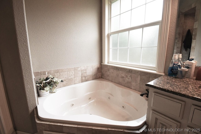 2463 S Park Hl, Tahlequah, OK 74464 - bathroom with a tub with jets, a textured wall, and vanity